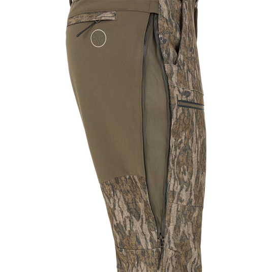 Side view of olive green Non-Typical Pursuit Softshell Pant with Agion Active X2 hunting pants featuring a vertical zippered thigh vent.