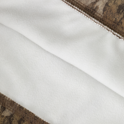 Closeup of soft white fleece bordered by brown camo-pattern stitching, showcasing the texture and detail of the Non-Typical Youth Performance Hoodie with Agion Active X2 by Nontypical.