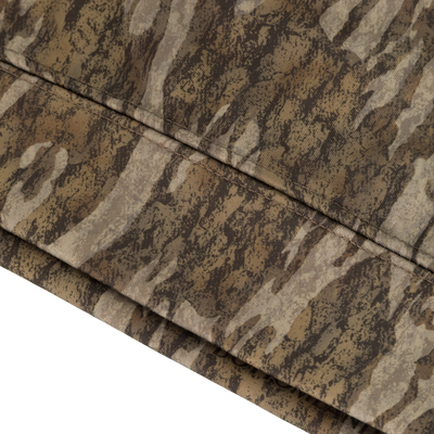 Close-up of folded fabric from the Non-Typical Youth Performance Hoodie with Agion Active X2 by Nontypical, showcasing a brown and tan camo pattern with subtle vertical and horizontal seams.