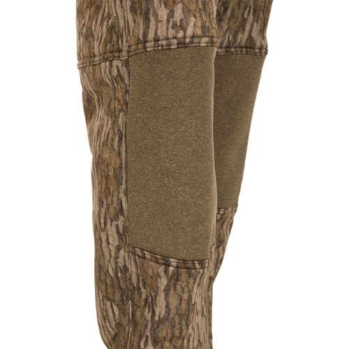 A pair of Silencer Soft Shell Pants with Agion Active XL, featuring camouflage design, adjustable waist, and pockets, designed for quiet hunting.