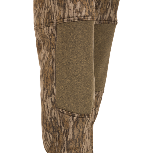 A pair of Silencer Soft Shell Pants with Agion Active XL, featuring camouflage design, adjustable waist, and pockets, designed for quiet hunting.