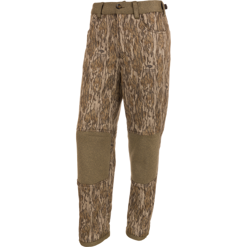 Silencer Soft Shell Pant with Agion Active XL, featuring a camouflage pattern, front and rear pockets, adjustable waist and ankles, and elastic foot stirrups for hunting.