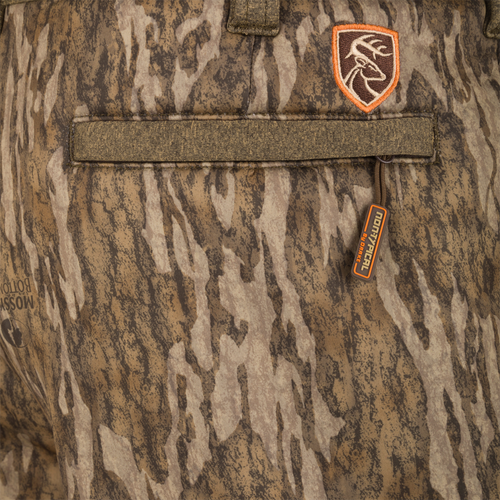 Close-up of Silencer Soft Shell Pant with Agion Active XL, showing camouflage design, adjustable waistband, and zipper details. Suitable for hunting with scent control technology.