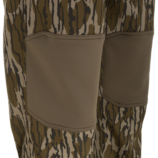 Close-up of Nontypical Youth Endurance Pant with brown and olive camo, solid brown reinforced knees, and durable microfiber stretch fabric.