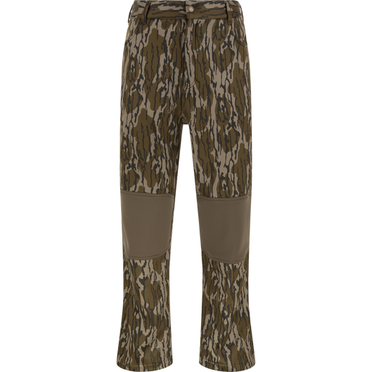 Nontypical Youth Endurance Pant in Mossy Oak Original Bottomland features reinforced knee patches, front button, zipper, belt loops, and is made from a microfiber stretch fabric. Displayed against a white background.