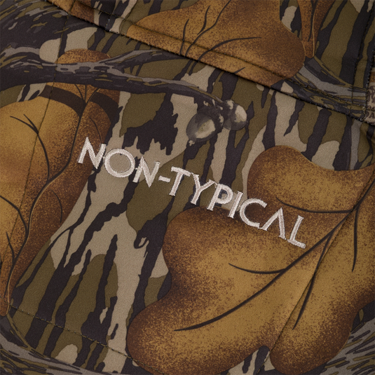Close-up of a Non-Typical Endurance Hooded Full Zip Jacket with Scent Control in a brown and green camouflage pattern with the text NON-TYPICAL embroidered in white.