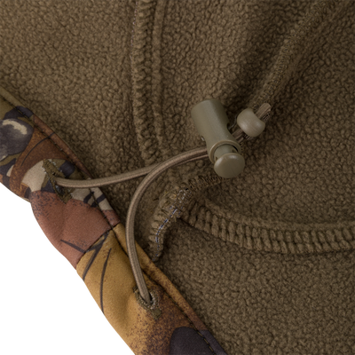 Close-up of an olive Non-Typical Endurance Hooded Full Zip Jacket with Scent Control in fleece, featuring camouflage-patterned trim and an adjustable drawstring toggle.