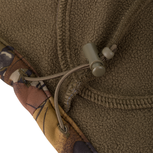 Close-up of an olive Non-Typical Endurance Hooded Full Zip Jacket with Scent Control in fleece, featuring camouflage-patterned trim and an adjustable drawstring toggle.