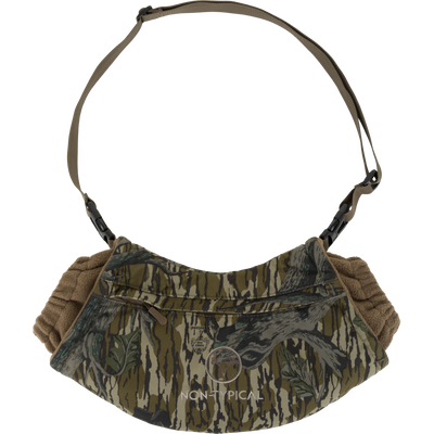 The Non-Typical Handwarmer Muff with Scent Control by Nontypical in Mossy Oak Original Treestand features scent control, a zippered front pocket, and an adjustable strap, with NON TYPICAL on the front.