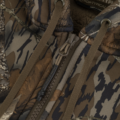 Close-up of the Non-Typical Slacker Quarter Zip Hoodie by Nontypical, featuring a camouflage pattern, drawstrings, branded tag, and warm polyester microfiber with a soft fleece-lined interior.