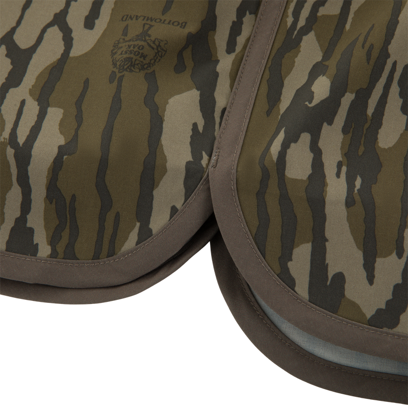 Close-up of Mossy Oak “Bottomland” camouflage fabric pads, resembling the material of Drake Lake Shore Shorty Short, highlighting durability for outdoor water adventures.