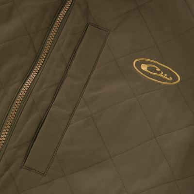 Close-up of the Delta Quilted Jacket by Lifestyle in olive green, featuring a zipper closure, vertical welt pocket, and gold oval logo—crafted for premium outdoor performance.
