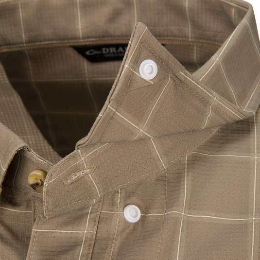 Close-up of a tan plaid Lifestyle Wingshooter Hunter Creek moisture-wicking button-down shirt with white collar buttons.