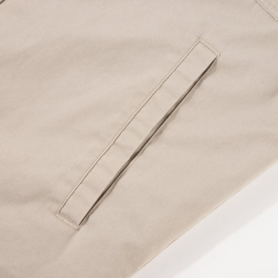 Close-up of the Drake Campfire Canvas Shirt Jac Hoodie, highlighting a single welt pocket with neat stitching, exemplifying durable design for versatile, stylish warmth.