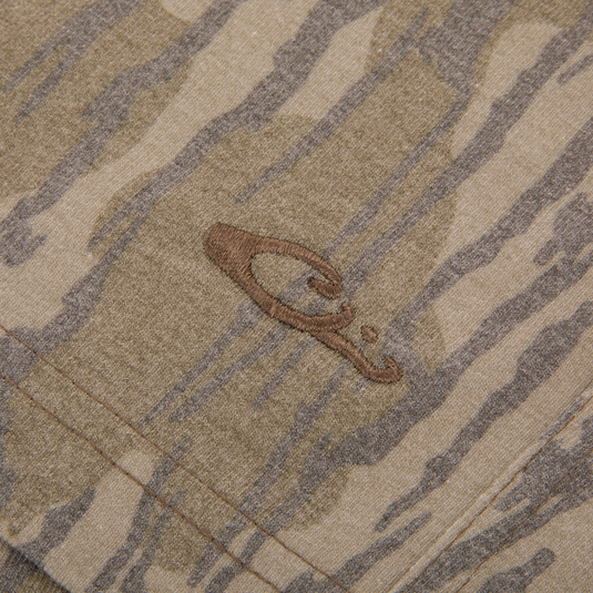 Close-up of Drake Tri Blend Campus Short, showcasing camo-patterned fabric with a stitched seam and embroidered logo, highlighting its soft, stretchable, quick-drying material.