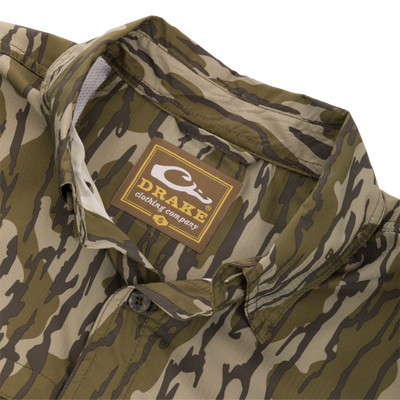 Youth Long-Sleeved Flyweight Camo Hunting Shirt with tiger-stripe camo, button-down collar, vented cape back, and Drake label, laid flat showing classic fit.