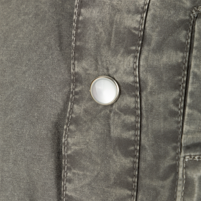 Close-up of the Cinco Ranch Western Acid Washed Cotton Shirt, highlighting a faux pearl snap and detailed stitching on the fabric, emphasizing Western design features.