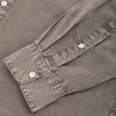 Close-up of the Cinco Ranch Western Solid Acid Wash Long Sleeve Shirt, highlighting a pocket flap and fabric belt with silver-rimmed snap buttons.