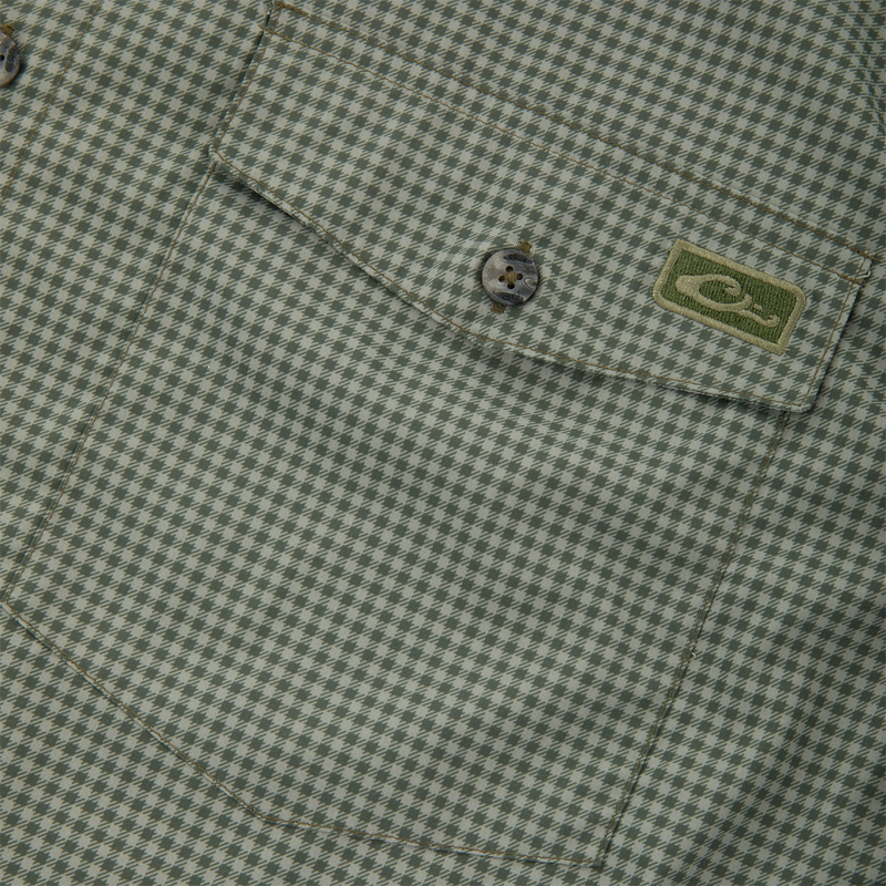 Close-up of Frat Gingham Check Button-Down Long Sleeve Shirt's chest pocket with green houndstooth fabric, buttoned flap, and embroidered logo patch.
