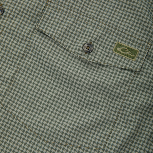 Close-up of Frat Gingham Check Button-Down Long Sleeve Shirt's chest pocket with green houndstooth fabric, buttoned flap, and embroidered logo patch.