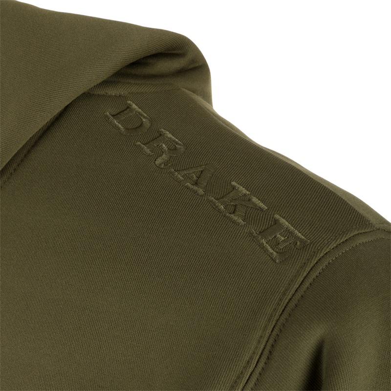 Alt text: Close-up of Drake Back Eddy Embossed Logo Hoodie, showcasing raised logo on polyester fabric. Features DWR coating, kangaroo pocket, and adjustable hood drawstrings. Ideal for outdoor activities.