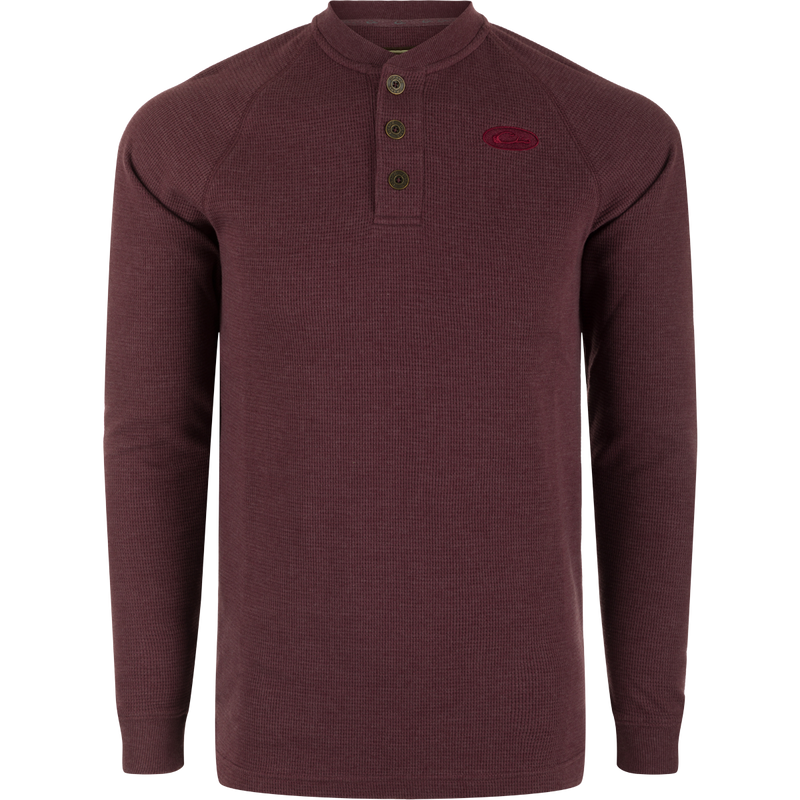 A Weston Lakes Waffle Long Sleeve Henley by Drake: Mélange fabric, raglan sleeves, metal logo buttons, rib knit collar and cuffs, split tail hem. Ideal for hunting and outdoor activities.