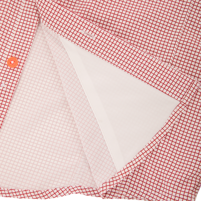 Close-up of the Drake Wingshooter Trey Grid Check Shirt's front placket, highlighting the orange button and inner interfacing layer for technical performance.