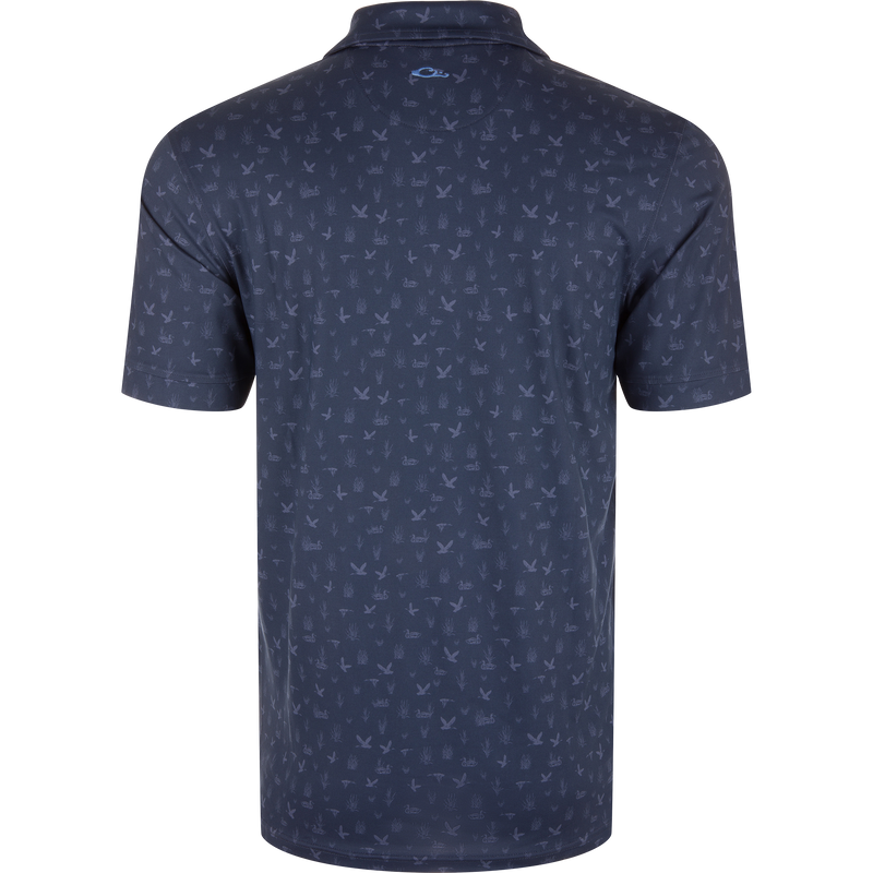 Marsh Duck Polo featuring a dark navy, bird-and-reeds pattern with a simple knit collar and contrasting logo, ideal for golf or casual wear.