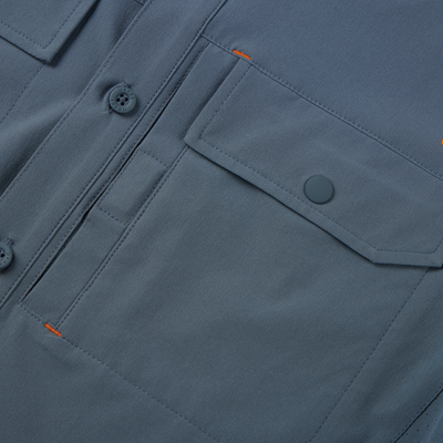 Lake Shore Performance Short Sleeve Shirt featuring a close-up of its button-through flap chest pocket and Magnattach closure, showcasing technical design and functionality.