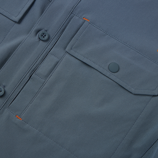 Lake Shore Performance Short Sleeve Shirt featuring a close-up of its button-through flap chest pocket and Magnattach closure, showcasing technical design and functionality.