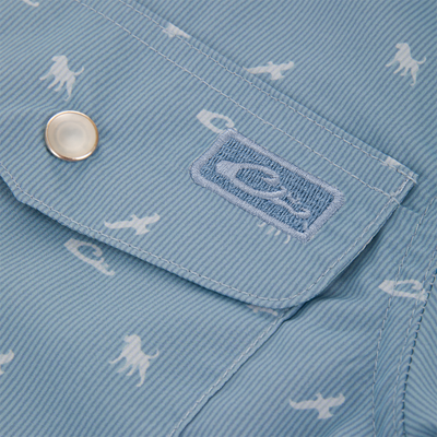Cinco Ranch Western Short Sleeve Shirt flap, featuring a metal snap and embroidered logo, with sea creature print on light-blue, fine-striped fabric.