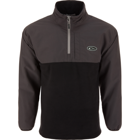 The MST Quarter Zip Refuge Eqwader Jacket by Waterfowl is a black and dark gray pullover with a half-zip front, high collar, long sleeves, left chest logo, and casual design inspired by wader gear.