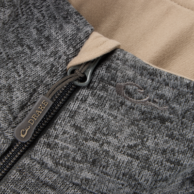 Close-up of a gray Fall Brake Sweater Fleece Vest by Sale, featuring a YKK zipper with DRAKE pull, subtle logo above the zip, and a light tan inner lining for stylish contrast.