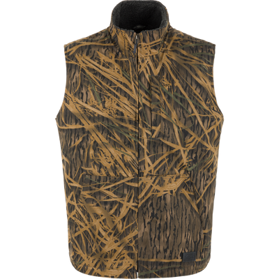 Lifestyle Canvas Sherpa Lined Work Vest in a brown and green camouflage grass pattern with a zippered front and a dark sherpa-lined interior.