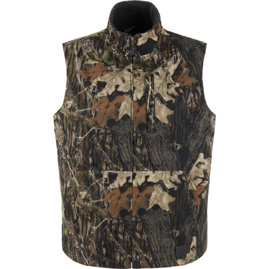 Lifestyle Canvas Sherpa Lined Work Vest in Mossy Oak Original Break Up, a water-resistant, camo-print sleeveless zip-up vest with a high collar and front zippered pockets.