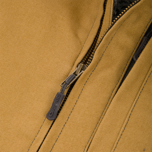 Close-up of a tan Canvas Sherpa Lined Work Vest, showing the metal zipper and dark, sherpa-lined interior.