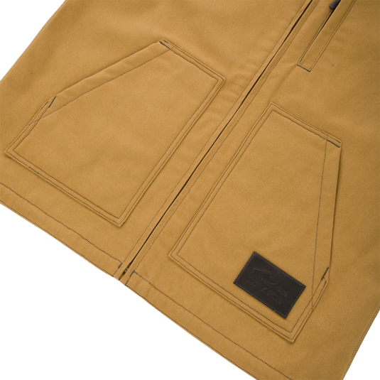 Lifestyle Canvas Sherpa Lined Work Vest in tan, featuring a zipper closure, two front patch pockets, and a rectangular branded patch on the lower right pocket.