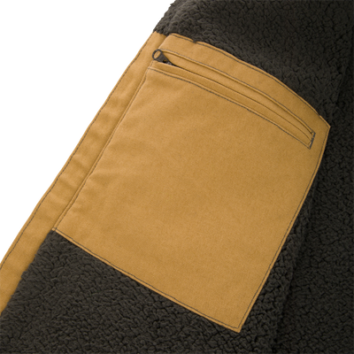 Tan canvas pocket with a zippered closure on a Lifestyle Canvas Sherpa Lined Work Vest, set against a dark, sherpa-lined fleece interior.