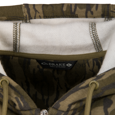 Close-up of the Three End Full Zip Work Hoodie, showcasing camo-print with fleecy white lining, olive-green drawcords, and Drake – Made in Bangladesh label.