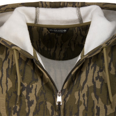 Close-up of the Three End Full Zip Work Hoodie, featuring a camouflage print, metal zipper, drawcord hood, and visible Drake – Made in Bangladesh label.