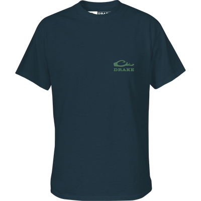 The Lifestyle Youth Mallard Bow Tie T-Shirt is a dark blue short sleeve tee featuring a small green Drake Waterfowl logo and “DRAKE” on the upper left chest, with a classic crew neckline.