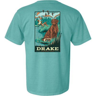 Waterfowl Lab T-Shirt featuring a vintage-style graphic of a retriever by a pond, marsh grasses, ducks, and DRAKE THE WATERFOWL COMPANY text, ideal for hunting enthusiasts.