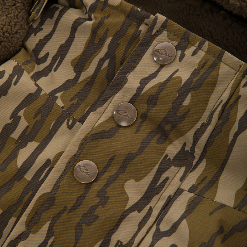 Close-up of the Throwback 80 Insulated Sport Bomber Jacket, featuring tiger-stripe camo, brass snap buttons, and peek of fleece lining.