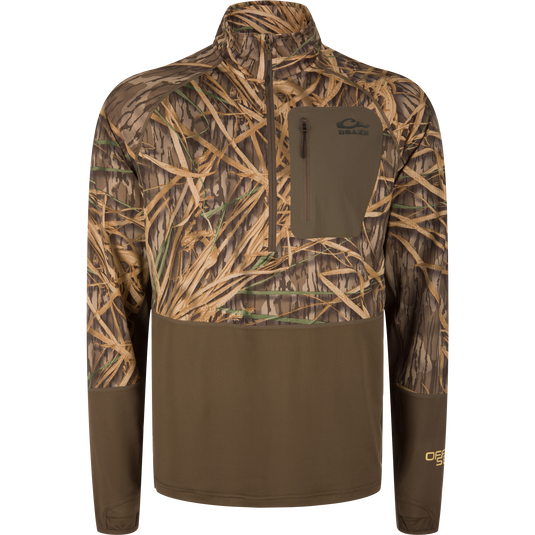 The Waterfowl EST Offset 1.0 Half Zip Pullover features Mossy Oak Original Shadow Grass camo, UPF30 protection, a chest zip pocket, partial front zip, and long sleeves for comfort and style.