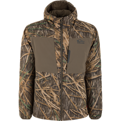 The Waterfowl LST BMF Jacket with Primaloft features tan and green grass camo, solid olive chest panels, a hood, water-resistant fabric, and the Drake logo on the left chest.