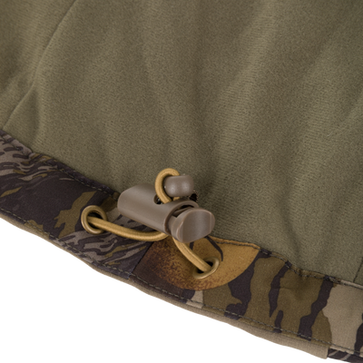 Olive green Drake X Ducks Unlimited LST BMF Jacket with Primaloft hem featuring a brown plastic drawstring toggle and elastic cord.
