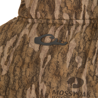 Close-up of LST BMF Vest with Primaloft, featuring Mossy Oak camouflage, rubberized emblem, and Magnattach chest pocket on windproof, breathable ripstop fabric with DWR finish.