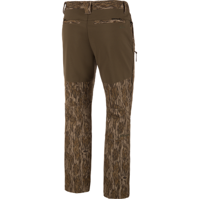 Back view of olive green MST Youth CommandXT Softshell Pant featuring a stretch waistband and camouflage print on the lower legs and seat.