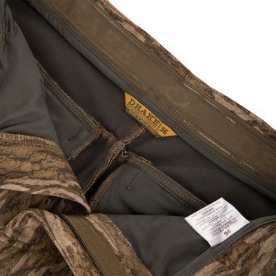 Interior view of MST Youth CommandXT Softshell Pant camouflage pants showing the stretch waistband, branded tag, and care label.