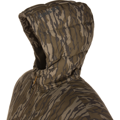 Close-up of BMF Down Jacket's camo print hood, with DRAKE text, zip front, and draw-cord adjusters, showcasing rugged insulation for hunting.